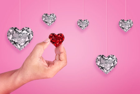 A Man hand holding red heart diamond, happy valentines day greeting background pinkの写真素材