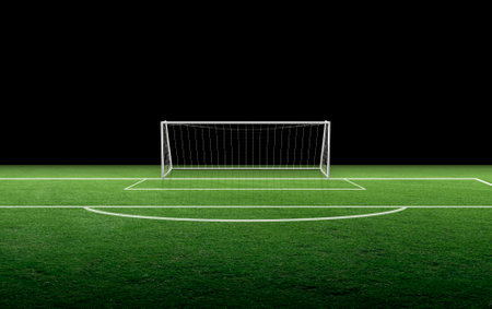 Soccer goal post and soccer net on green grassの写真素材