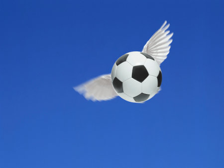 soccer ball have wings fly in the air on blue skyの写真素材