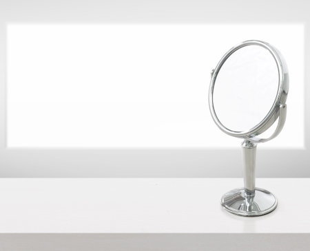Round mirror on white wooden table