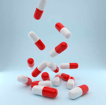 Falling pills on a blue backgroundの写真素材