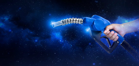 Hands holding Fuel nozzle floating in the Planet view from spaceの写真素材
