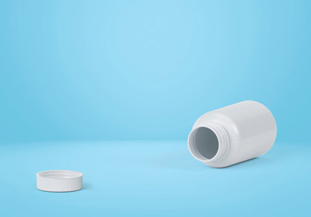 Blank plastic pill bottle on a light blue backgroundの写真素材