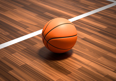 An official orange basketball ball on a hardwood basketball courtの写真素材