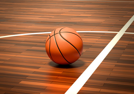 An official orange basketball ball on a hardwood basketball courtの写真素材