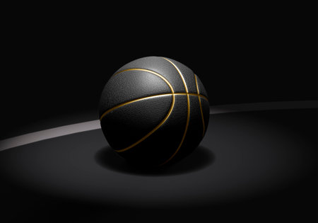 A black basketball with gold lines on a dark basketball courtの写真素材