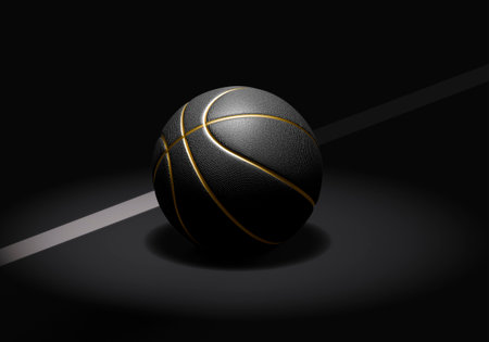 A black basketball with gold lines on a dark basketball courtの写真素材