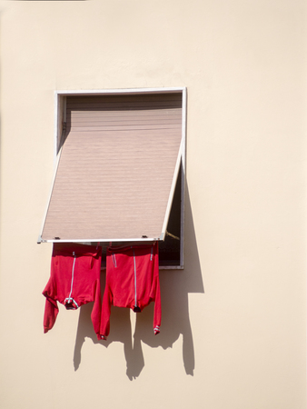 Hanging red Clothes land laundryの写真素材