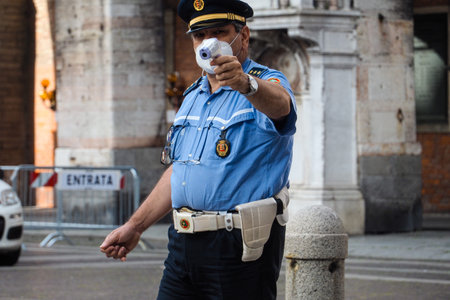 tighter controls at the street food market police officer check residents fever or temperature wearing protection facial mask to prevent against contagion of coronavirus  and control limited  accessのeditorial素材