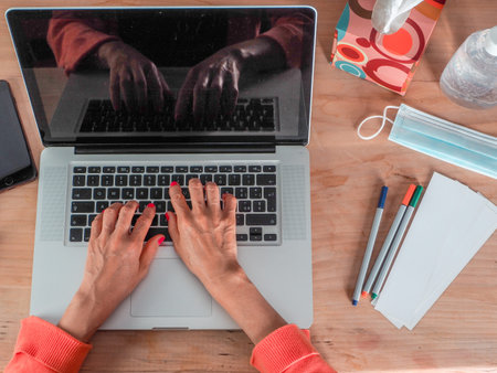 Woman hand s freelance working on a notebook laptop computer at home or home office with gel and...