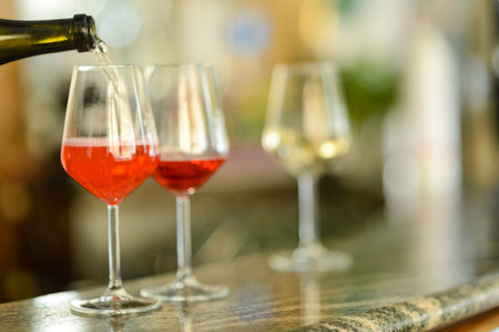 Cold white wine served in elegant glasses with selective focus, bokeh.