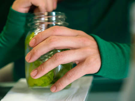 young man drinking fresh mojitoの写真素材