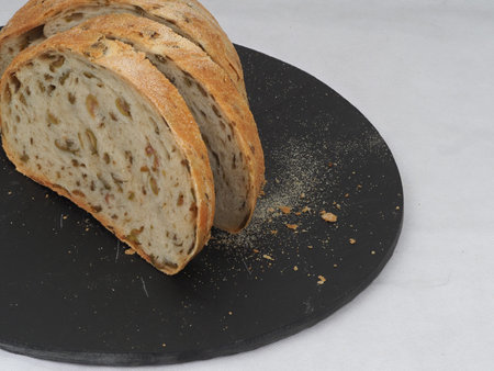 Olive loaf, olive bread, a bread laced with whole olives on white background