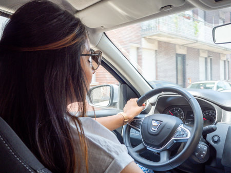 Beautiful business lady driving her car a cloudy day in summertimeの写真素材