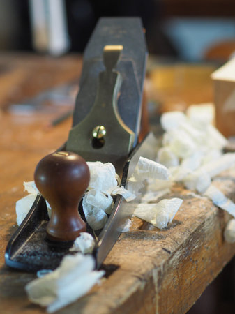 Close up of professional master artisan luthier painstaking detailed work on wood violin in a...