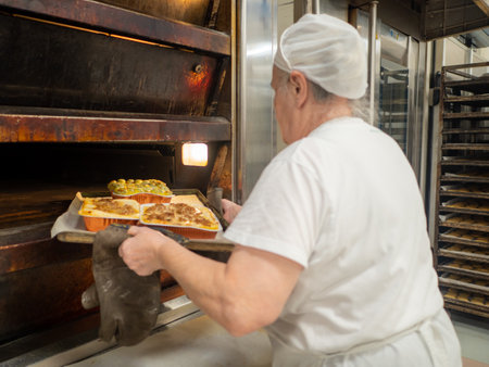 aged lady at work in big bakery restaurantのeditorial素材