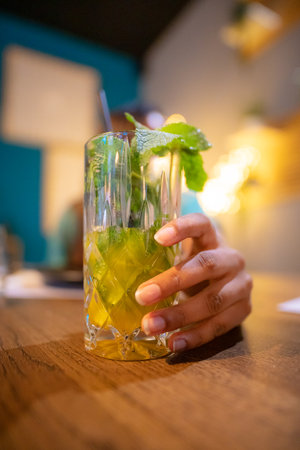 latino woman hand holding a mojito. Beverage lifestyle conceptの写真素材