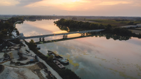sunset over a bridge in the river in autumnのeditorial素材
