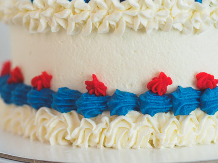 white blue red frosted icing cake isolated on studio white background. American flag colours....