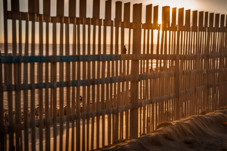 construction site of elevated wall near the sea to control illegal migration flows between states...