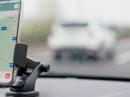 5g Smartphone displaying GPS navigation mounted on a car's dashboard, A1 A8 near Milan, Italy