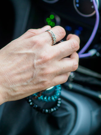 woman hand changes manual gear while driving a car