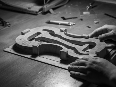 luthier violin maker luthier working with violin mold on center bot, corner blocks , bend ribs for a new classic handmade violin using moldの写真素材