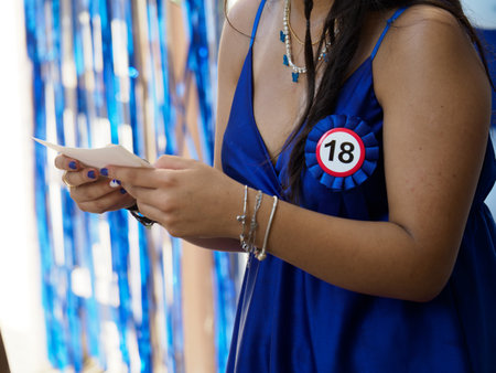 excited young woman at her 18 birthday opening family and friends presents.の写真素材