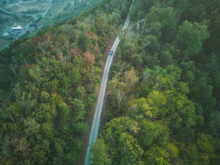 aerial photo of blue vintage retro dune buggy circulating on the road on the hills of Apennines in...