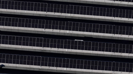 Solar panels arranged in rows on a vast solar farm, generating clean energy and contributing to...