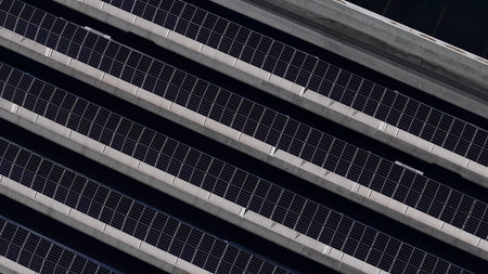Solar panel arrays harness sun power on a structured roof, showing the advancement of alternative...