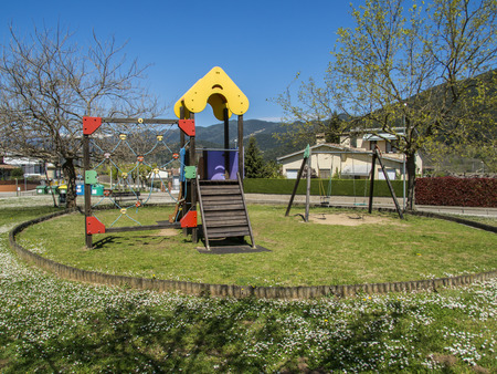 Children's playground with swings and slideの写真素材