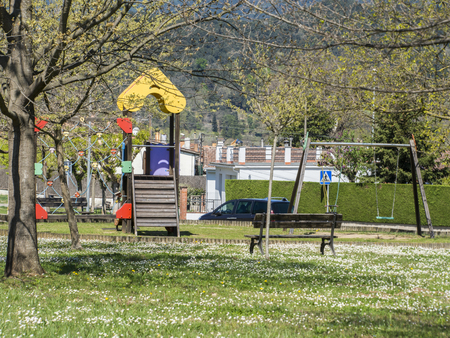 Children's playground with swings and slideの写真素材