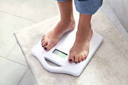 woman controlling her weight on a scale