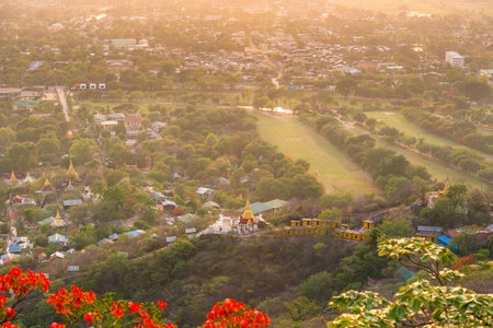 Beautiful and majestic view of pagodas and the city on top of the Mandalay Hillの写真素材