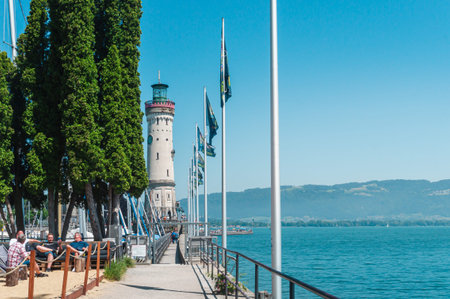 Panorama of the New lighthouse in the harbor of Lindau, Bavaria. A city in Germany, on an island in the middle of Lake Constance. Alps in the backgroundのeditorial素材