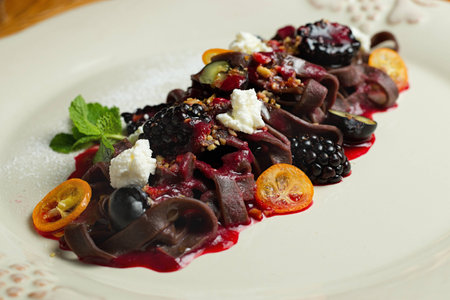 Chocolate pasta with raspberry sauce, whipped cream and fresh berriesの写真素材