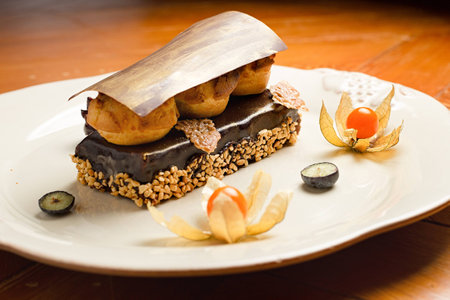 Decorated chocolate dessert on white plateの写真素材