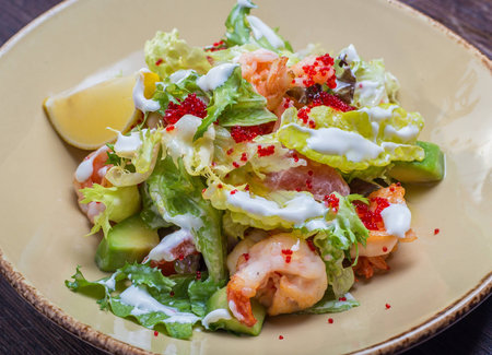 salad with shrimp and caviar on a plateの写真素材