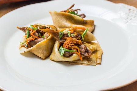 A stack of thin pancakes with honey and butterの写真素材