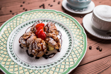 eclair with chocolate, cream and nuts