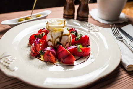 buratta salad in restaurnat on white plateの写真素材