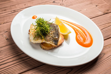 whitefish on plate restaurant on wooden tableの写真素材