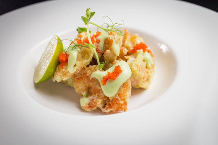 shrimp tempura with roe on white plate, restaurantの写真素材