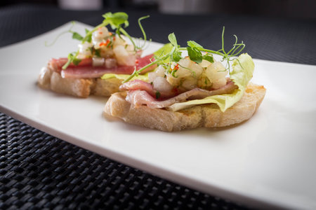 bruschetta with tuna on white palat, restaurantの写真素材