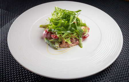 salad with arugula on white plate, restaurantの写真素材