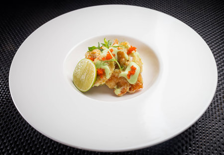 shrimp tempura with roe on white plate, restaurantの写真素材