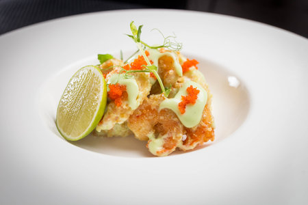shrimp tempura with roe on white plate, restaurantの写真素材