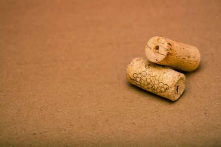 two wine corks stacked against a brown textured background  macro with copyspaceの写真素材