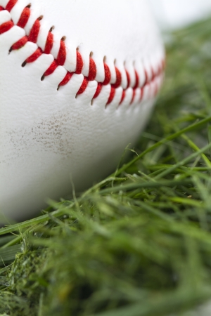 Angled macro shot of smudged baseball in grass の写真素材
